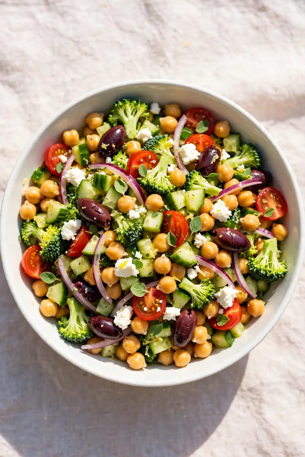 Mediterranean chopped broccoli and chickpea salad with herbs, olives, and feta