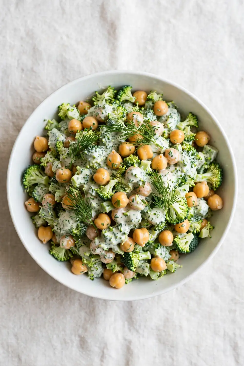 Chopped broccoli and chickpea salad with ranch style dressing and fresh dill