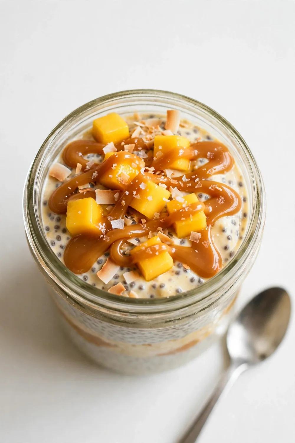 Chia pudding with salted caramel drizzle and mango in a jar