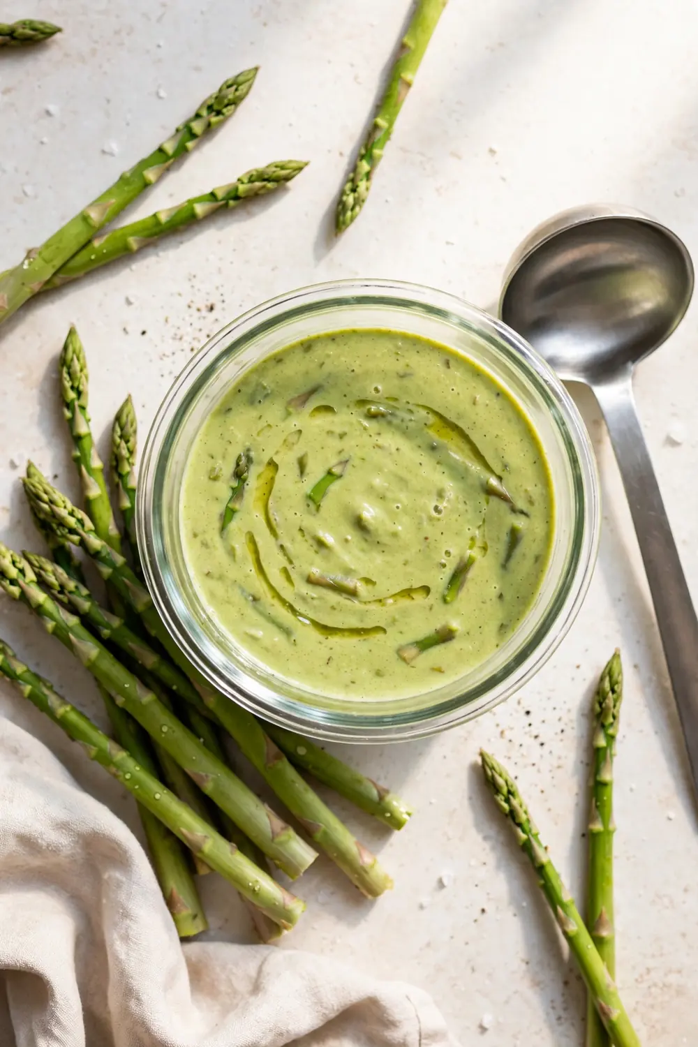 Creamy asparagus soup base packed for freezing with fresh spears nearby