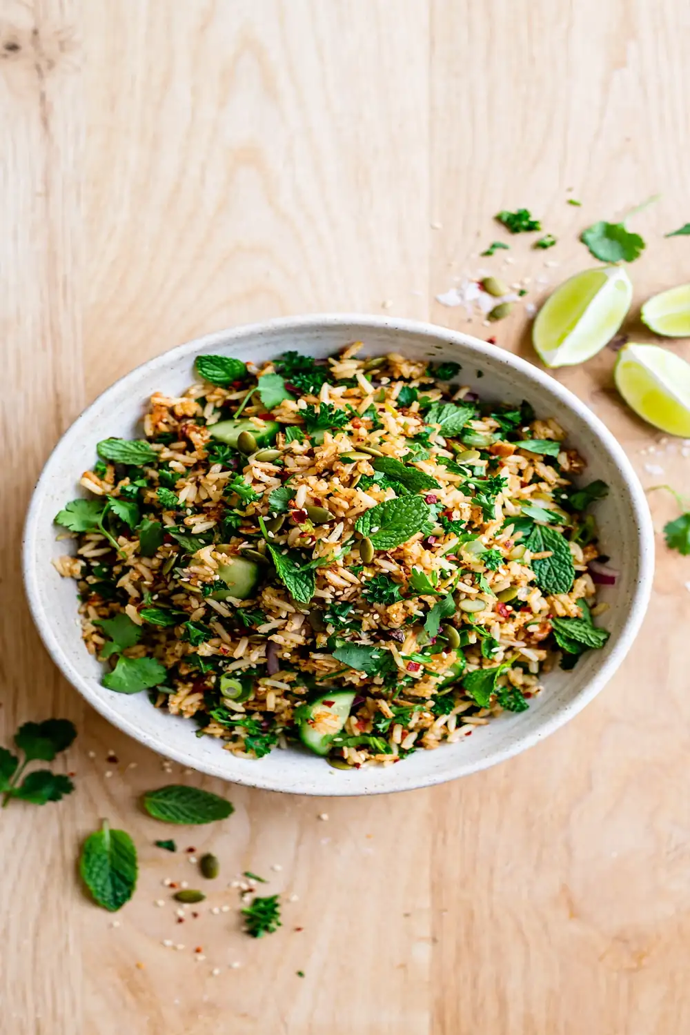 Classic herby crisped rice bowl with parsley mint cilantro and lime in a ceramic bowl