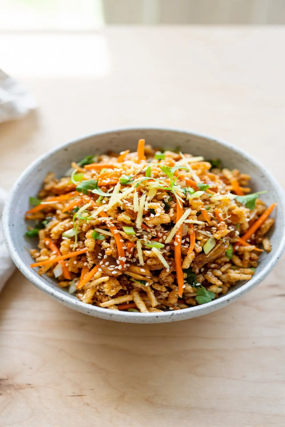 Sesame ginger crisped rice bowl with grated ginger carrots and sesame seeds
