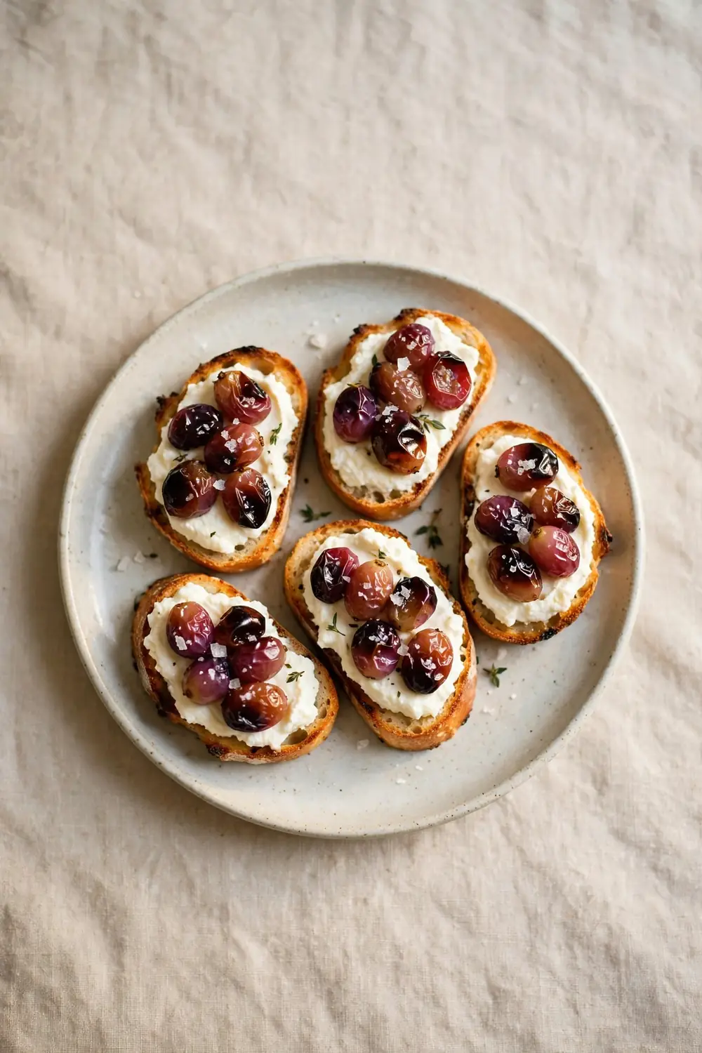 Roasted grape crostini with ricotta and flaky salt