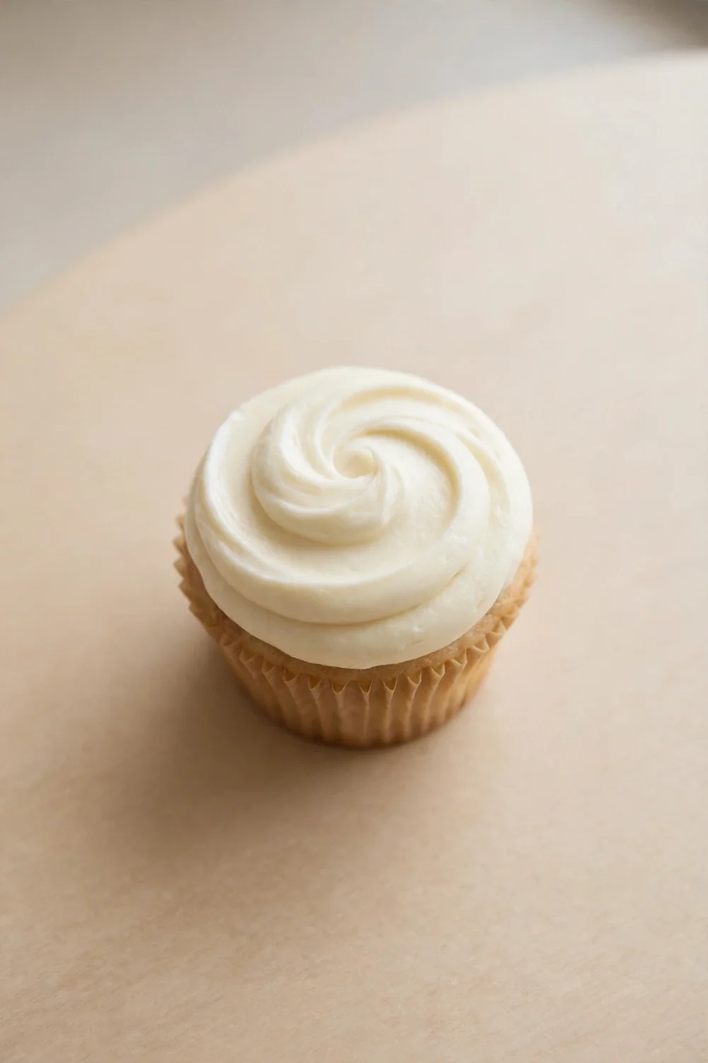 Single frosted cupcake with a smooth test swirl