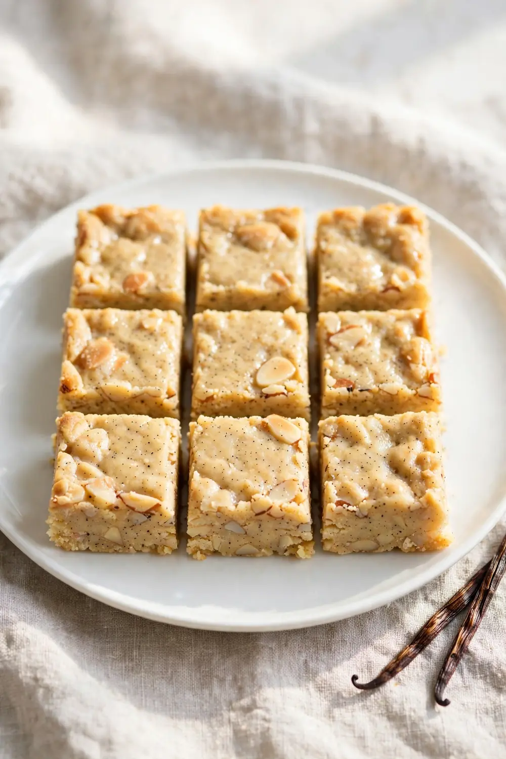 Almond butter protein bars with vanilla bean on a white plate