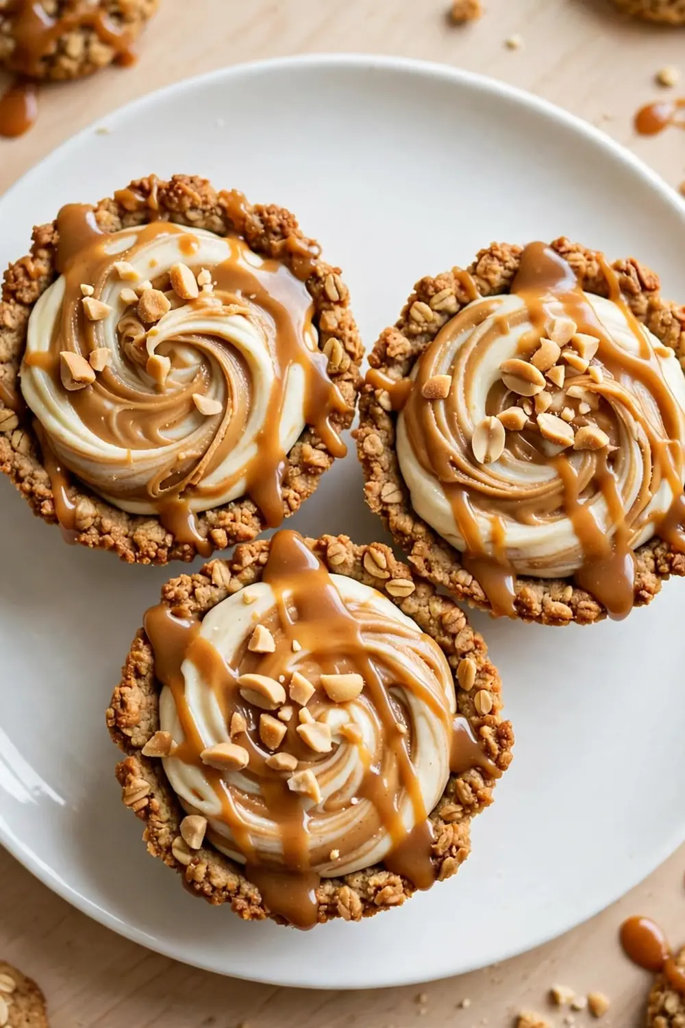 Oatmeal cookie sandwich pie with peanut butter swirl and caramel drizzle on a white plate