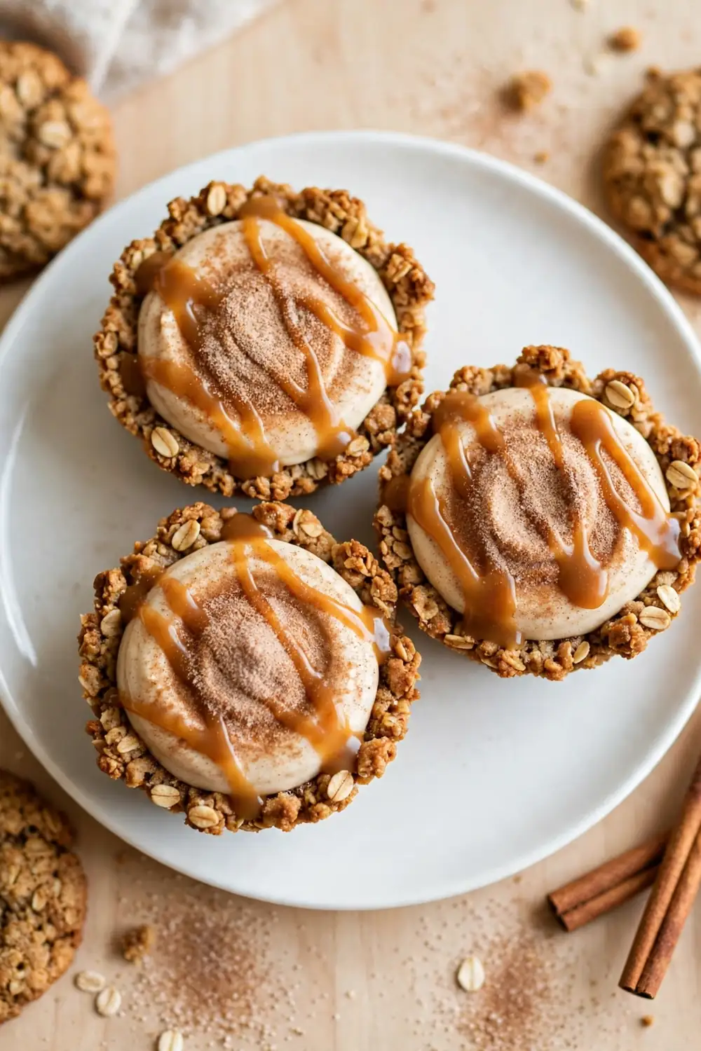 Oatmeal cookie sandwich pie with cinnamon sugar dusting and caramel drizzle on a white plate