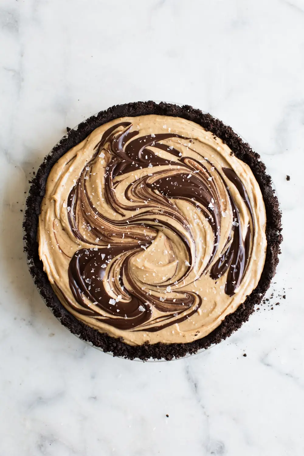 Whole peanut butter dessert with marbled chocolate swirls and flaky salt