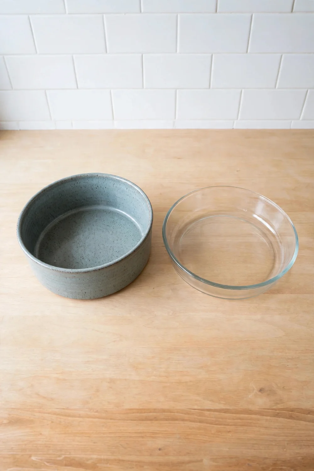 Wide shallow baking dish with layered casserole ready for the oven